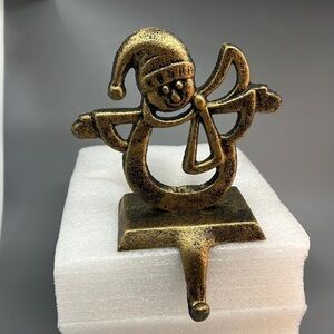 Elegant Snowman‎ Stocking Holder: A Classical Christmas Mantle Decoration